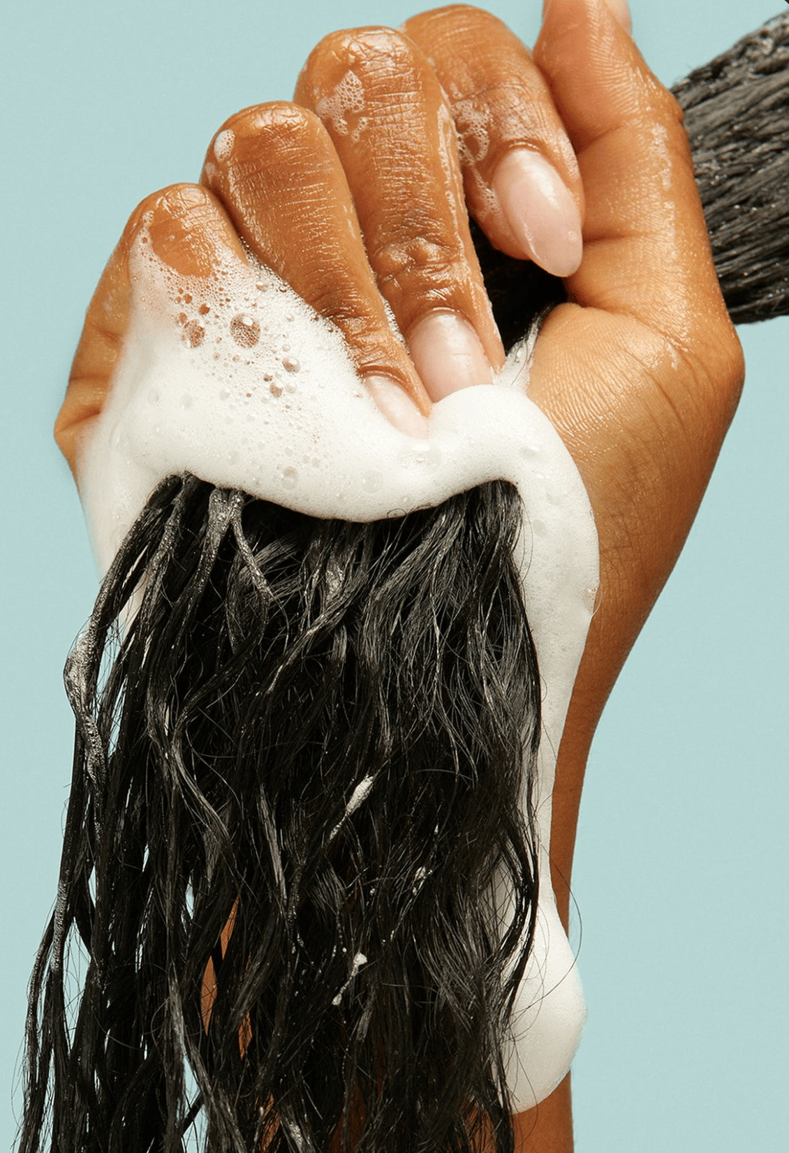 Hair being washed using hair care products.